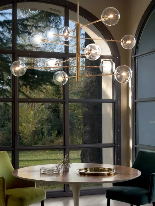 Lampada a sospensione Equinoxe in metallo con finitura ottone antico e diffusori in vetro soffiato trasparente di Ideal Lux